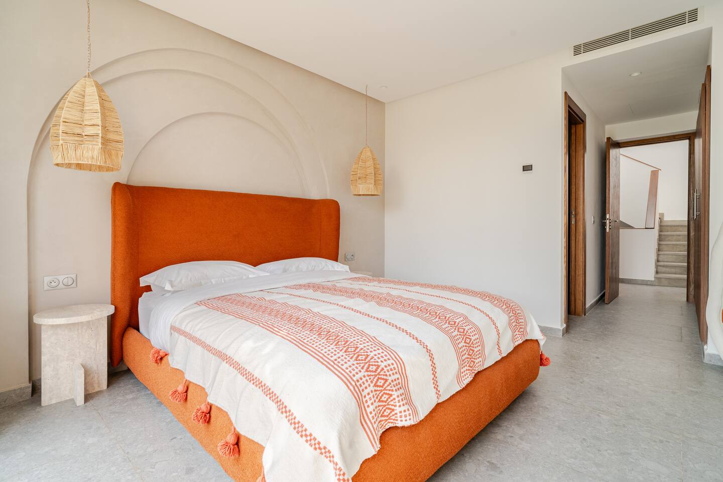 Bedroom with a king bed and terracotta headboard